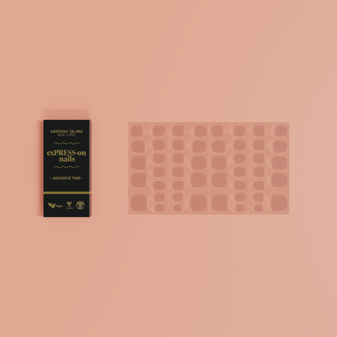 Manicure product set with adhesive tabs and packaging on a pink background