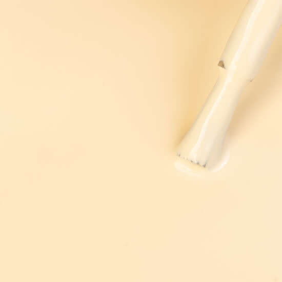 White cylindrical object on a beige background