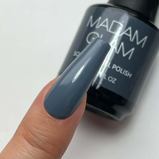 Nail polish bottle with a blue nail color swatch on a white background