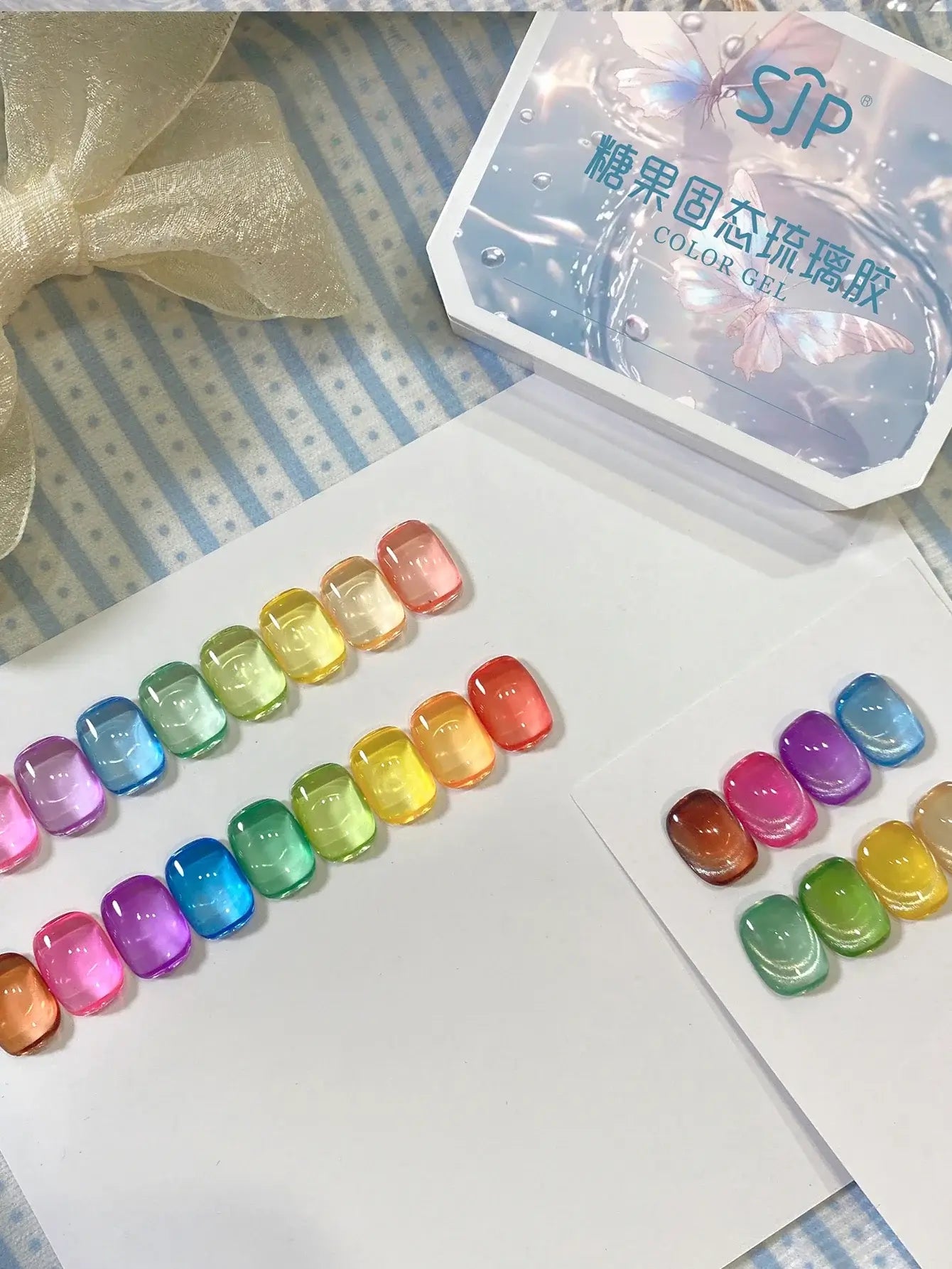 Colorful resin beads on a white surface with a box labeled 'Sip' in the background.