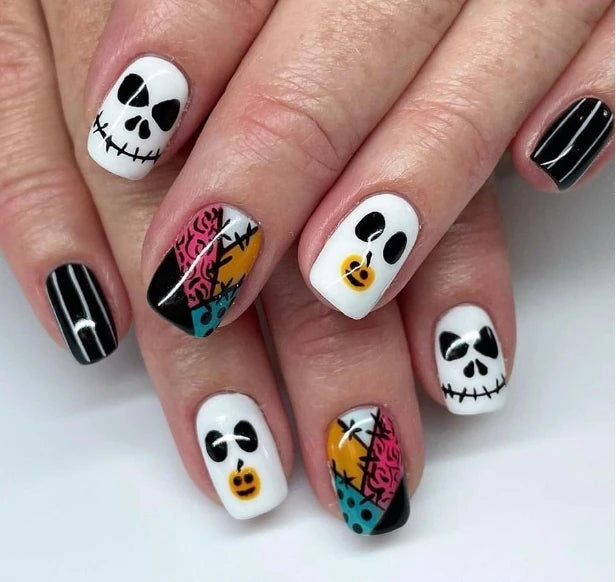 Nails with Halloween-themed designs on a white background