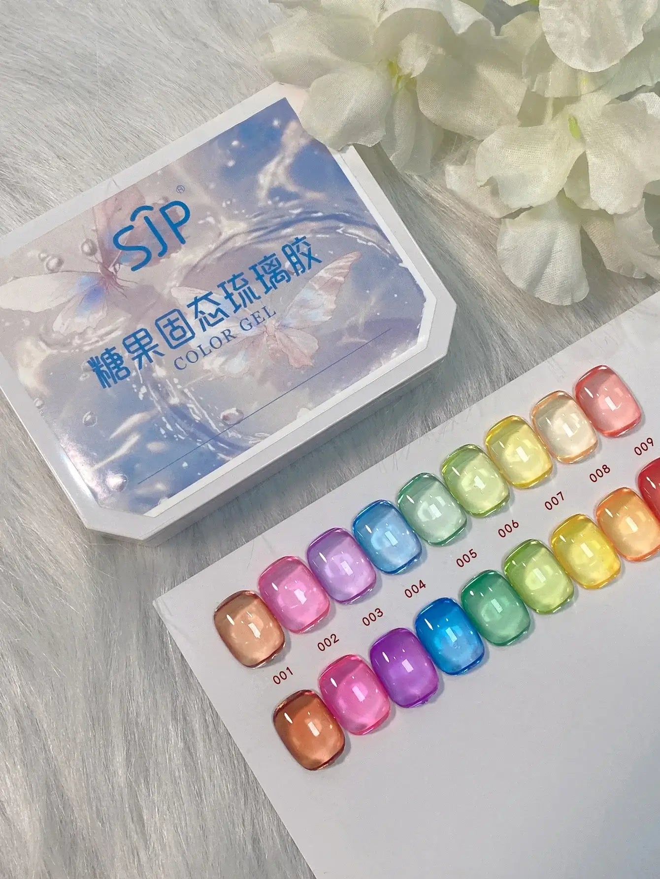 Color gel packaging with a selection of colorful gel samples on a light wooden surface.