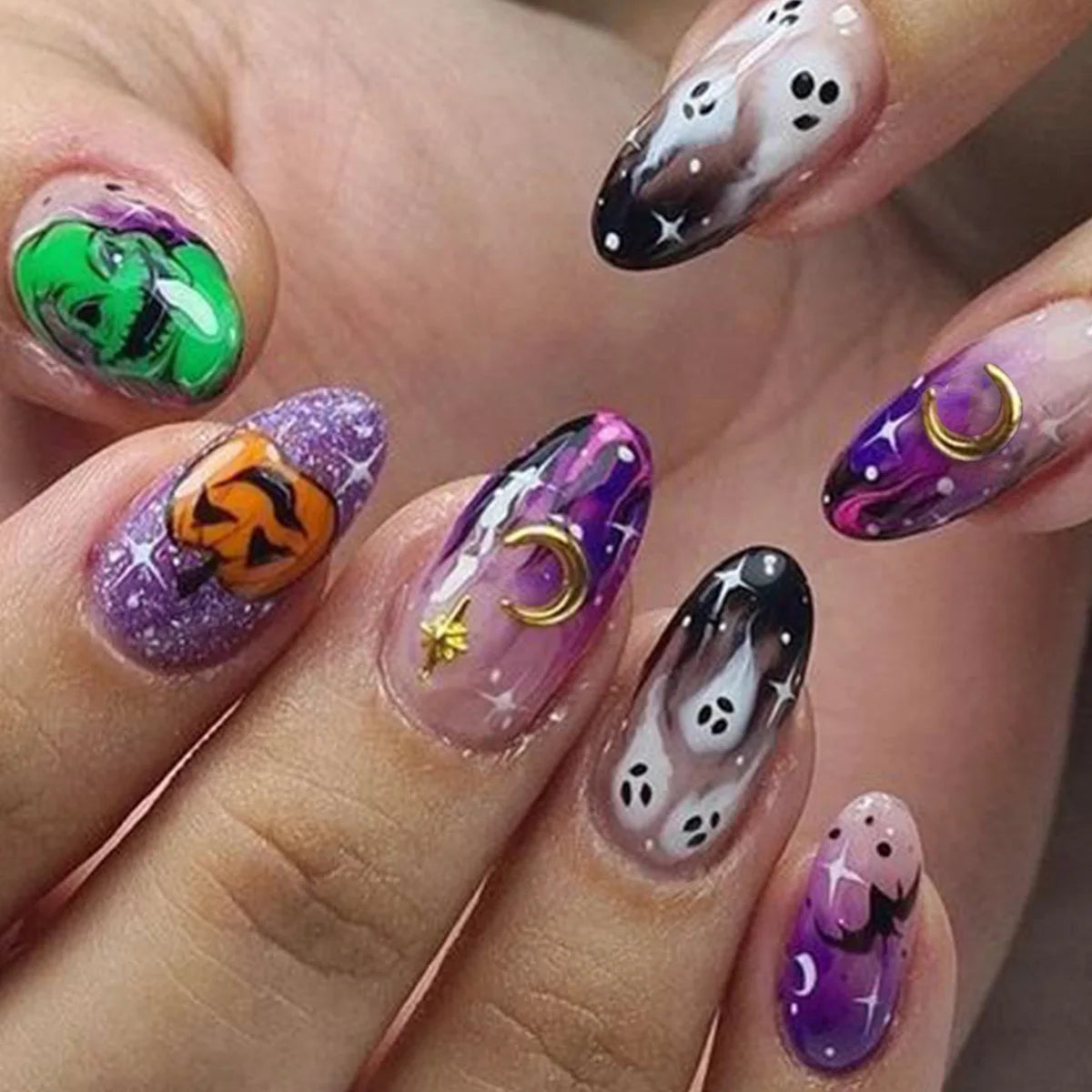 Halloween-themed nail art with colorful designs on a hand.