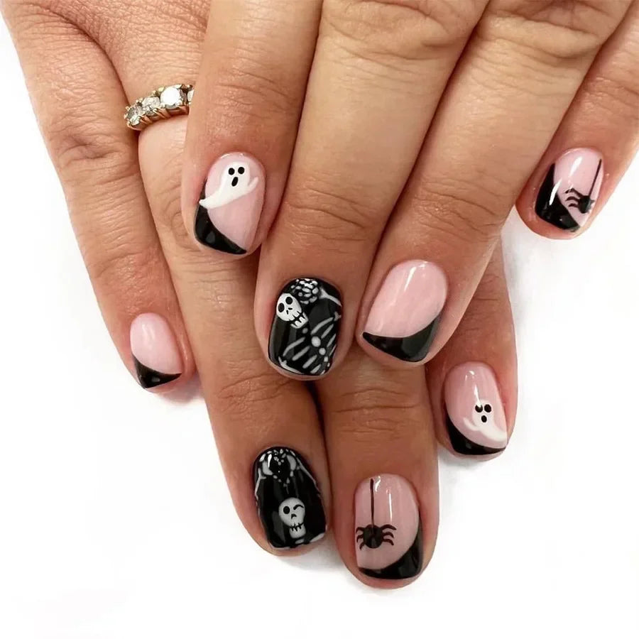 Nails with Halloween-themed designs on a white background
