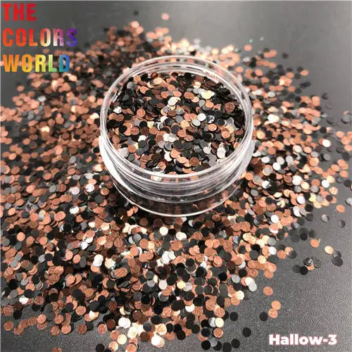 Clear container filled with multicolored glitter on a dark surface with 'The Colors World' branding.