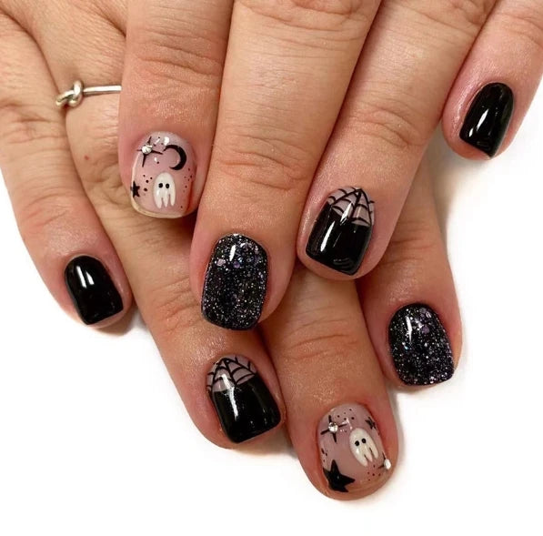 Nails with Halloween-themed designs on a white background