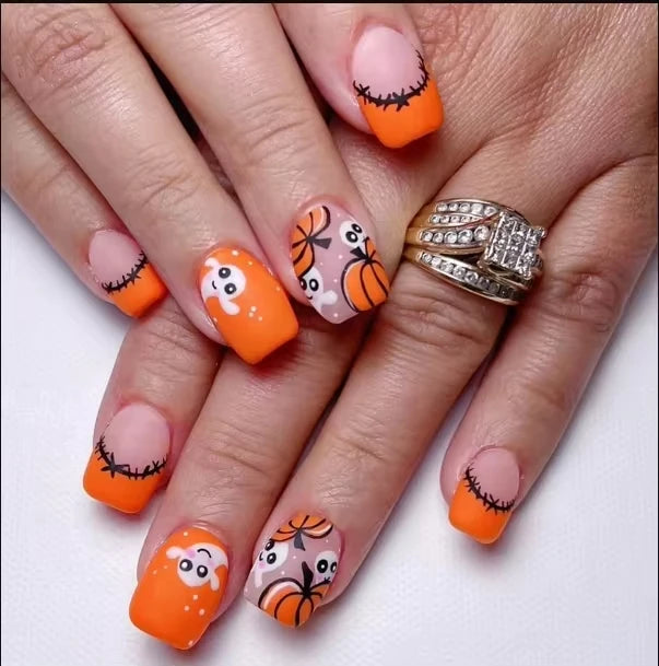 Nails with Halloween-themed designs on a white background