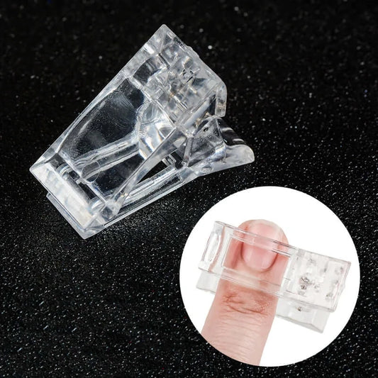 Clear plastic clip on a black background with a close-up inset showing its size relative to a finger.