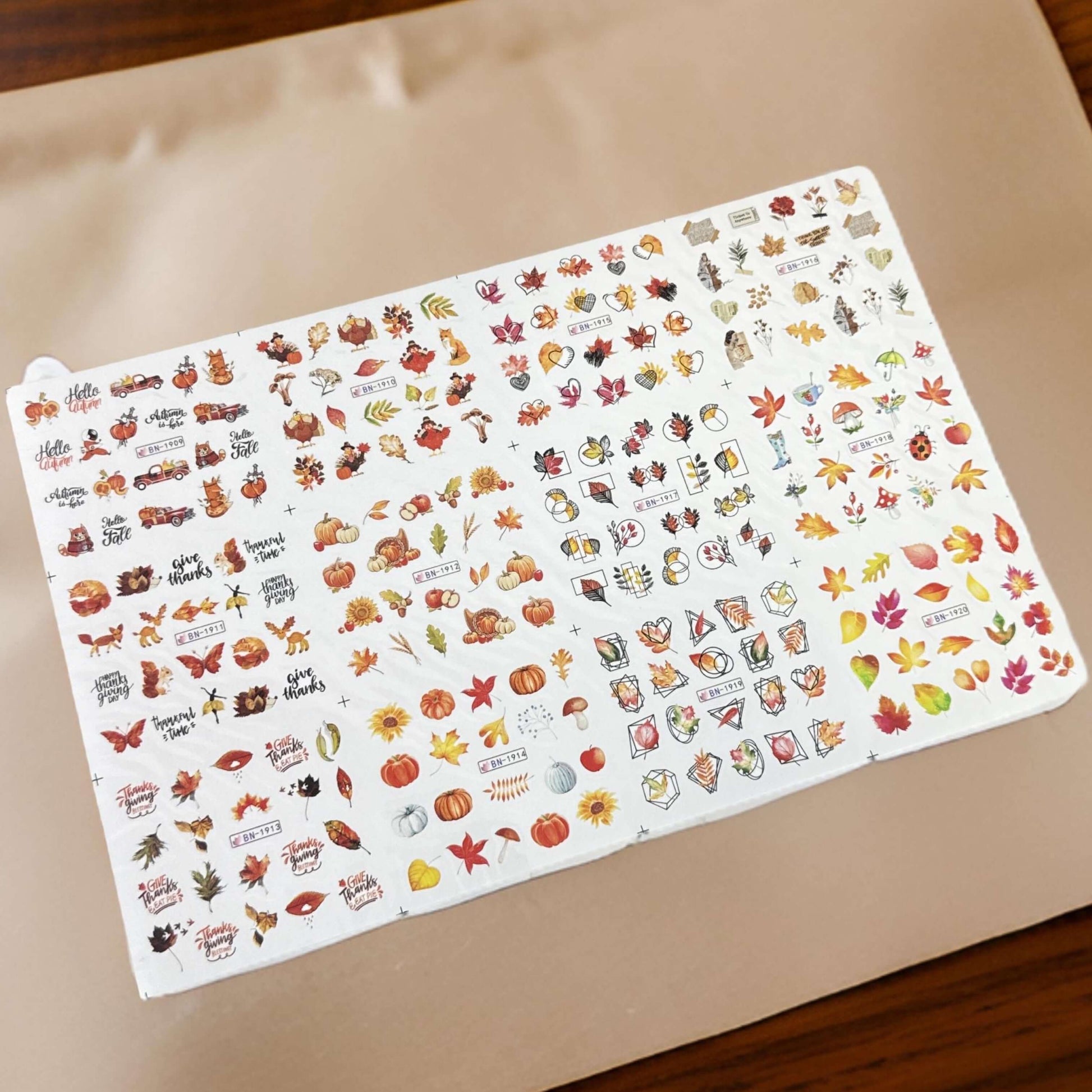 Sheet of autumn-themed stickers on a beige background