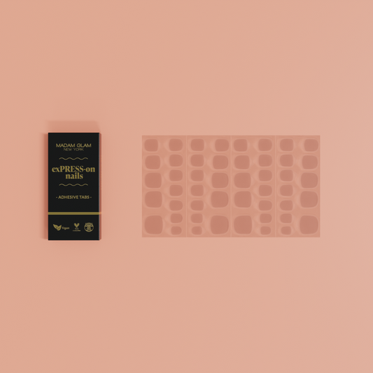 Manicure product set with adhesive tabs and packaging on a pink background