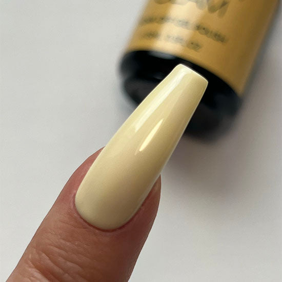 Nail with beige polish on a white background