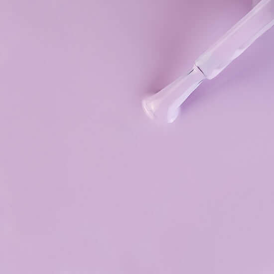 Transparent glass pipe on a light purple background