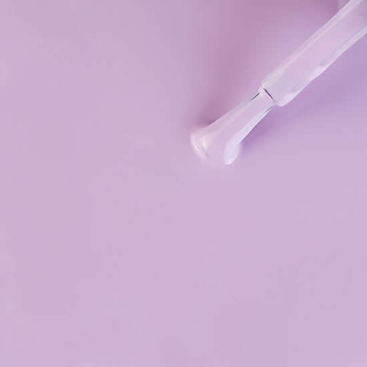 Transparent glass pipe on a light purple background