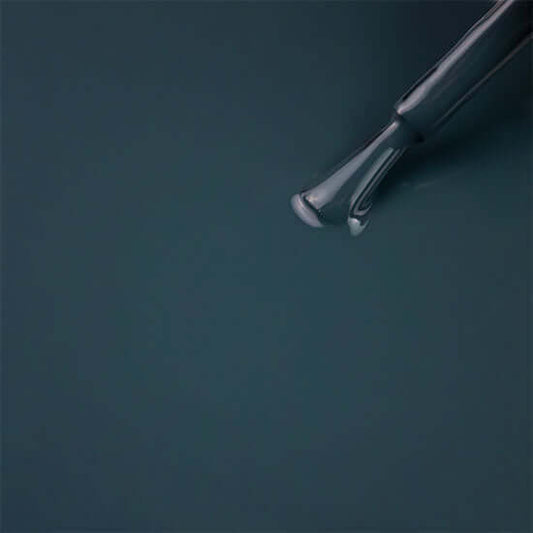 Pair of silver scissors on a dark green background