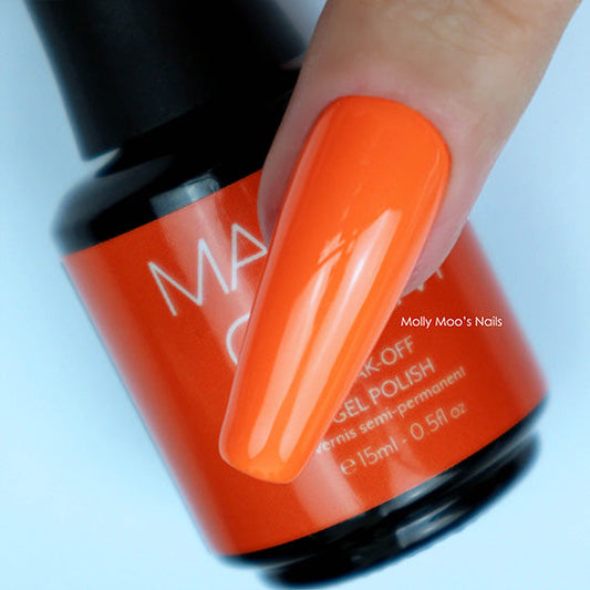 Orange nail polish on a finger with a bottle of Maxi Gel Polish in the background