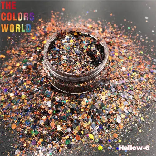 Jar of glitter with colorful glitter scattered around on a dark background, featuring 'The Colors World' branding.