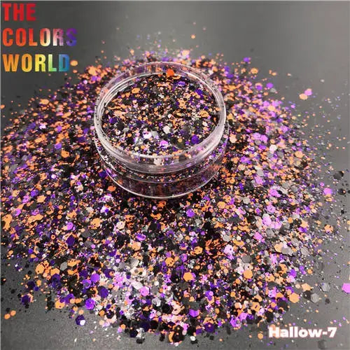 Multicolored glitter in a small container on a dark background with 'The Colors World' branding.