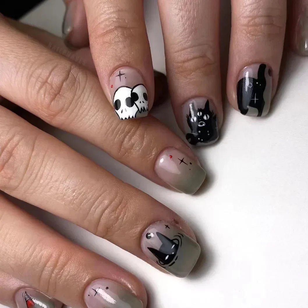 Nails with cat-themed designs on a white background