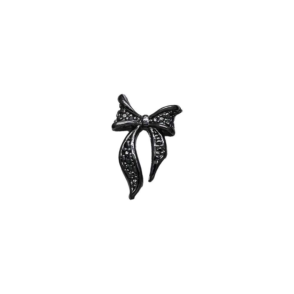 Black bow-shaped brooch on a white background