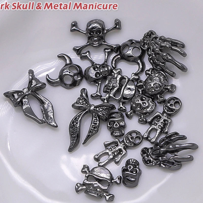 Collection of silver skull and metal-themed charms on a white background