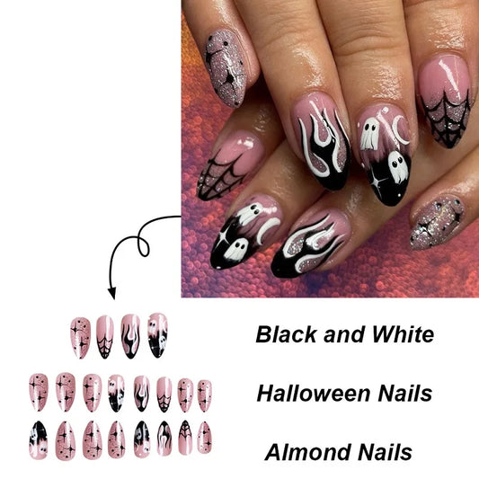 Halloween-themed nail art with black, white, and pink designs on almond-shaped nails.