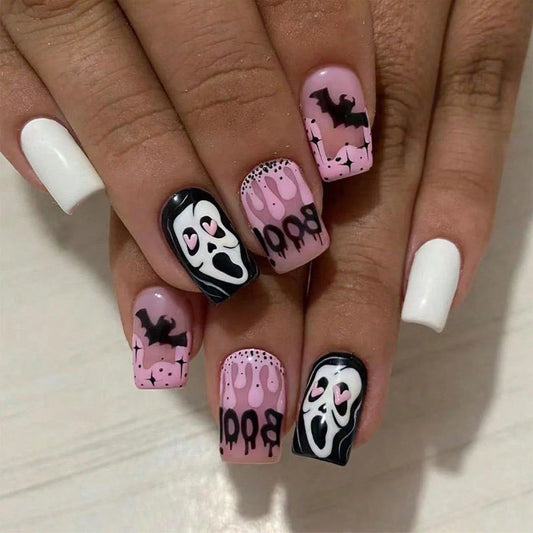 Nails with Halloween-themed designs on a light background