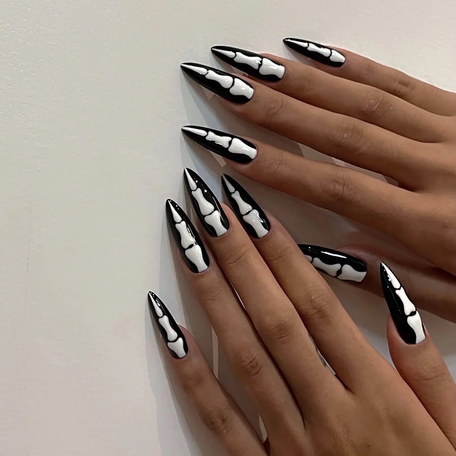 Nails with black and white design on a neutral background