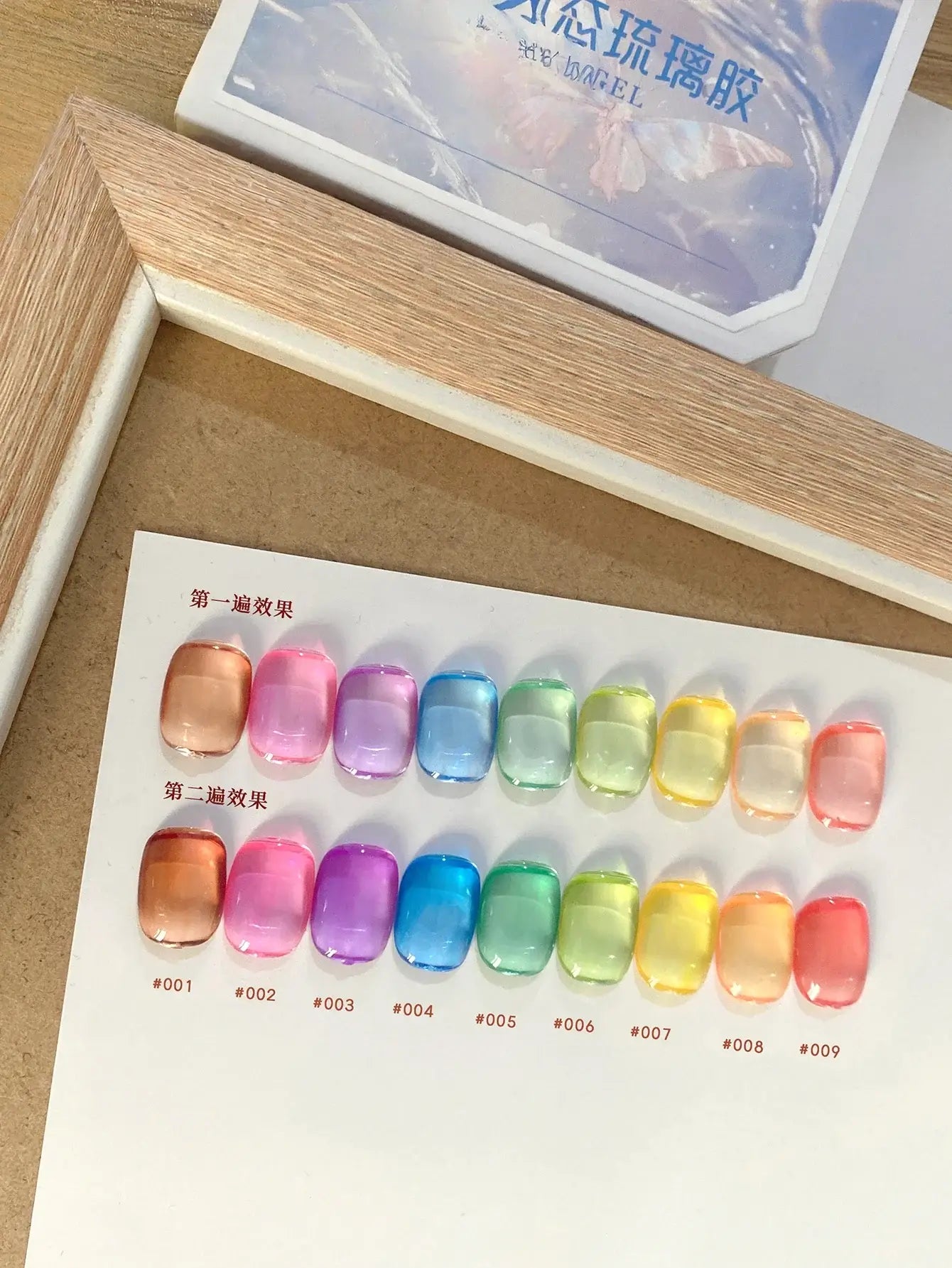 Color swatch with various colorful nail art designs on a wooden surface