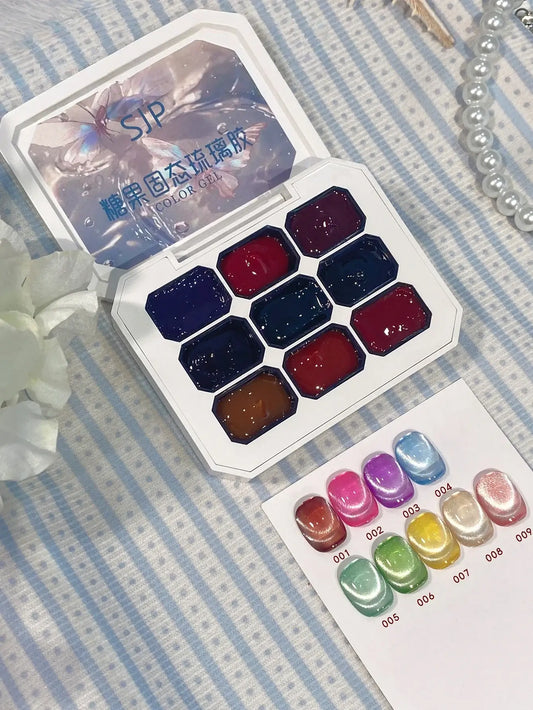 Set of watercolor paints in a white case on a striped fabric background